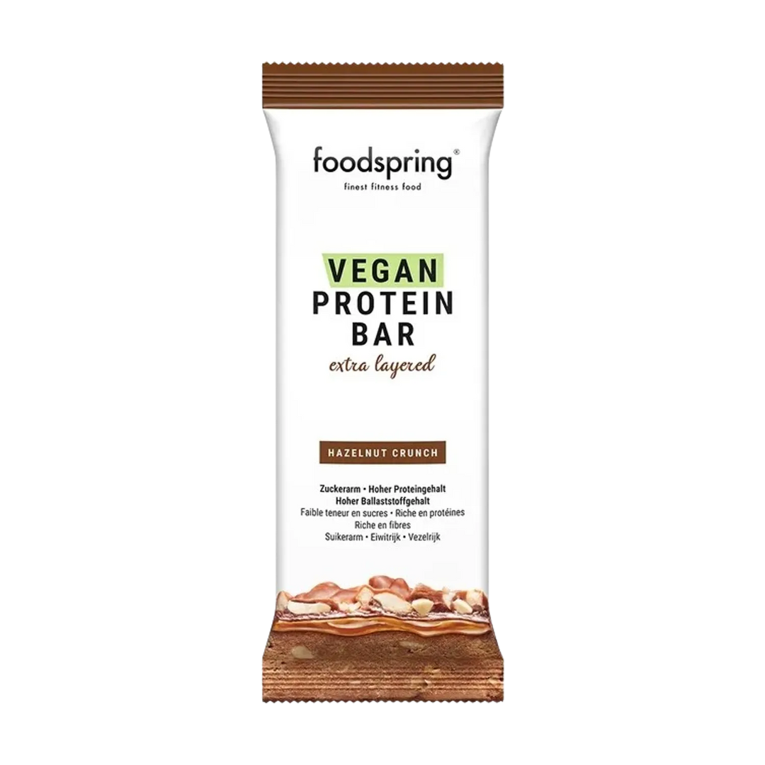 Indulge in the rich and decadent Foodspring Vegan Protein Bar Extra Chocolate, a 45g plant-based protein bar perfect for satisfying your sweet cravings