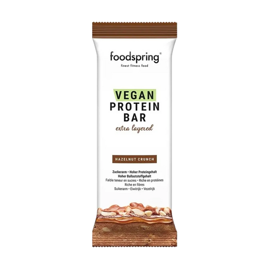 Indulge in the rich and decadent Foodspring Vegan Protein Bar Extra Chocolate, a 45g plant-based protein bar perfect for satisfying your sweet cravings