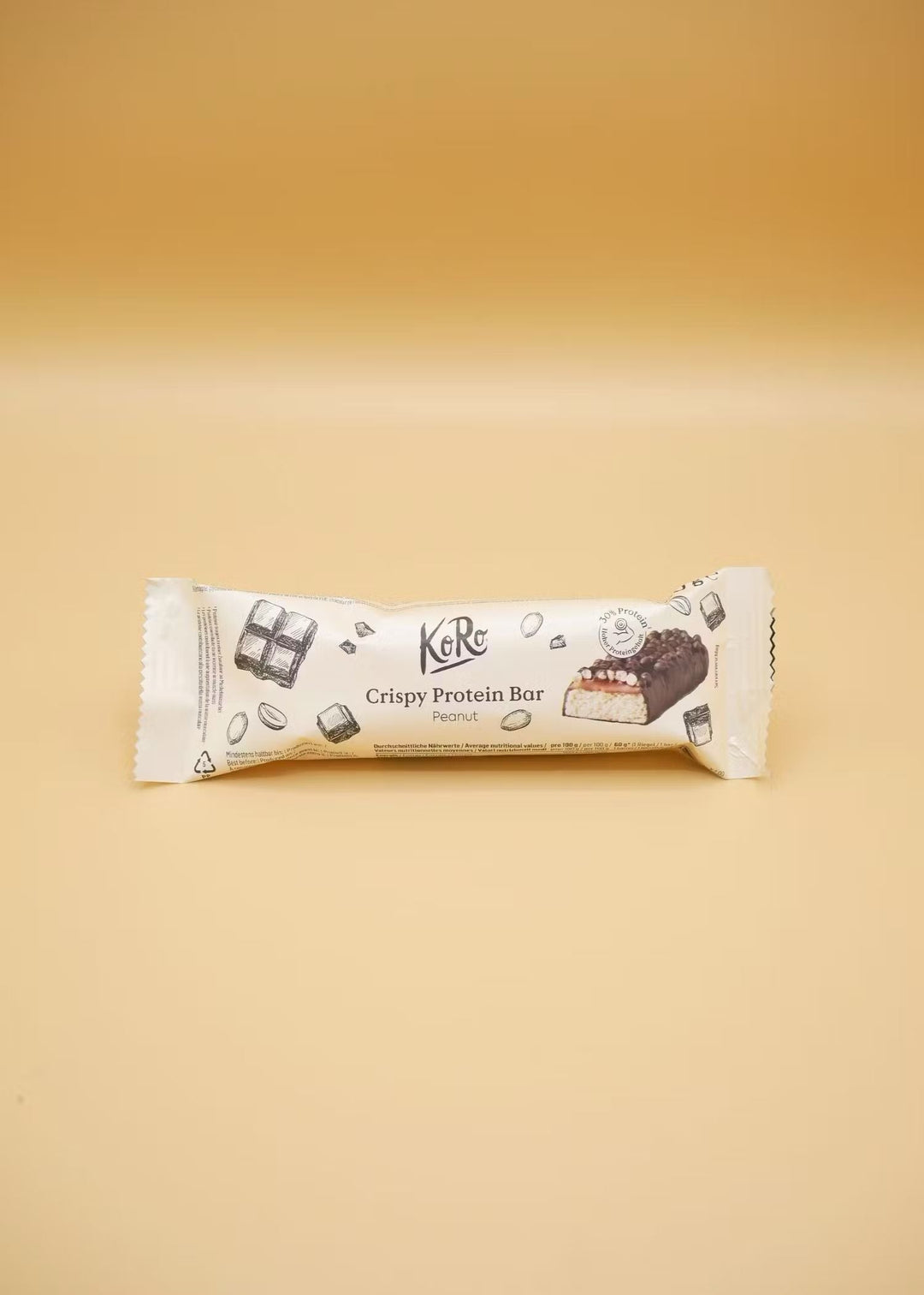 Close-up of KoRo Crispy Protein Bar Peanut with crunchy peanut pieces, chocolate coating, and 60g weight 