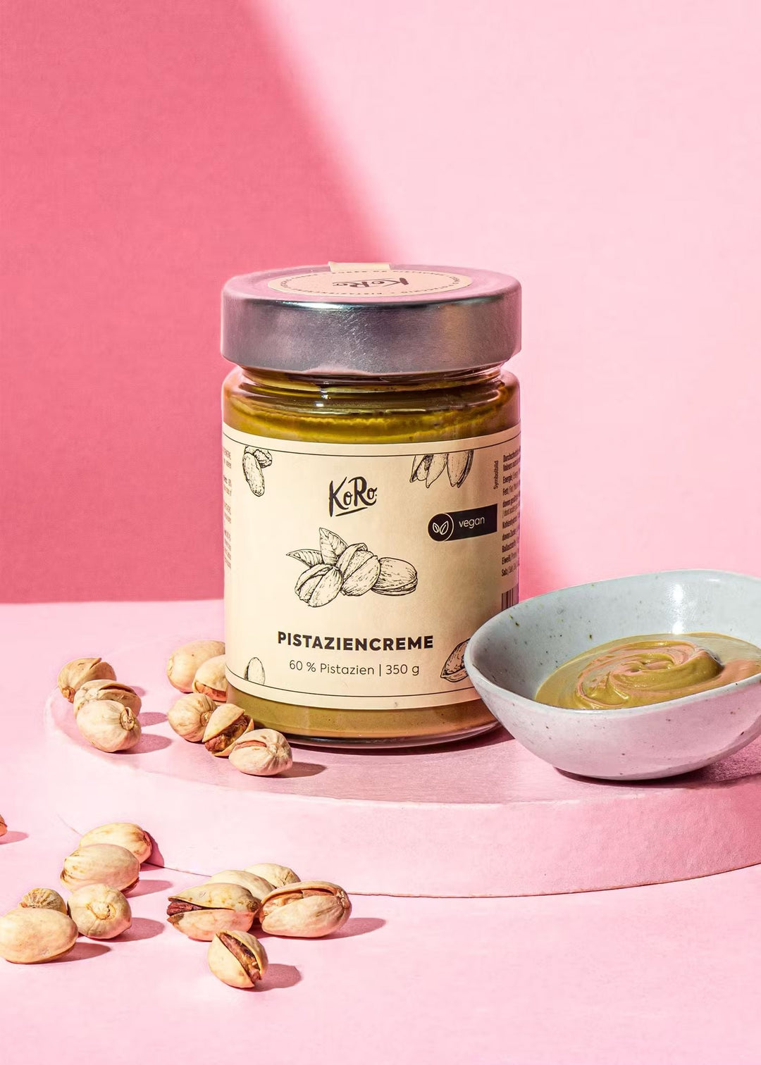 Vegan pistachio cream spread in a glass jar with green label