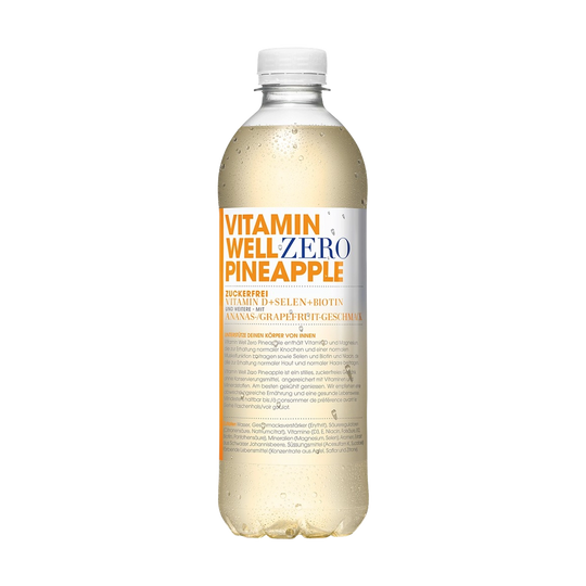 Vitamin Well Pineapple 500ml with fresh pineapple slices and green leaves